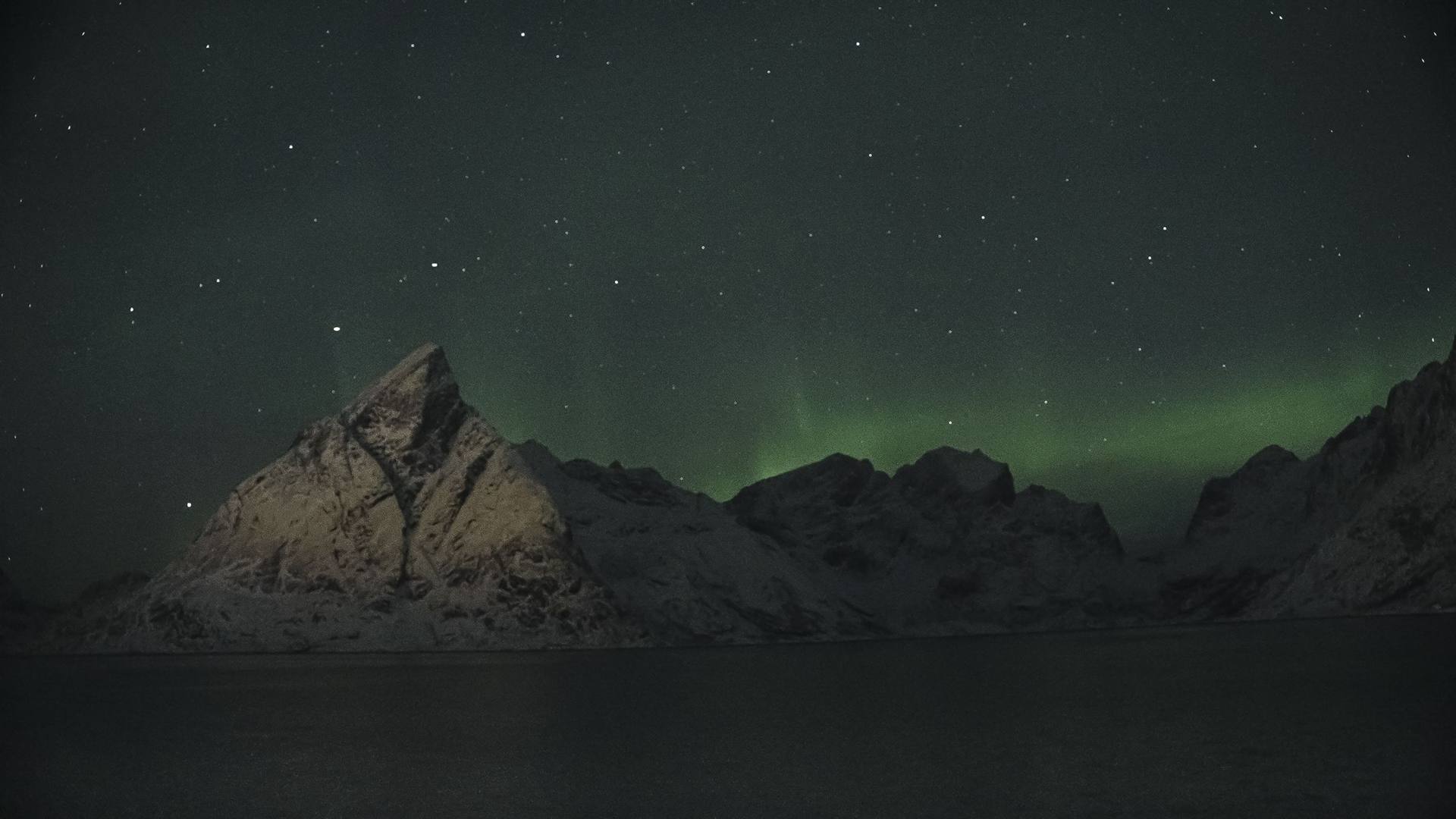 Northern lights over the mountains of the Lofoten Islands