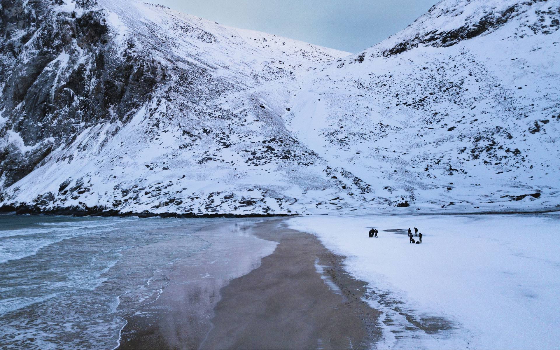Researchers collecting samples on a snowy beach