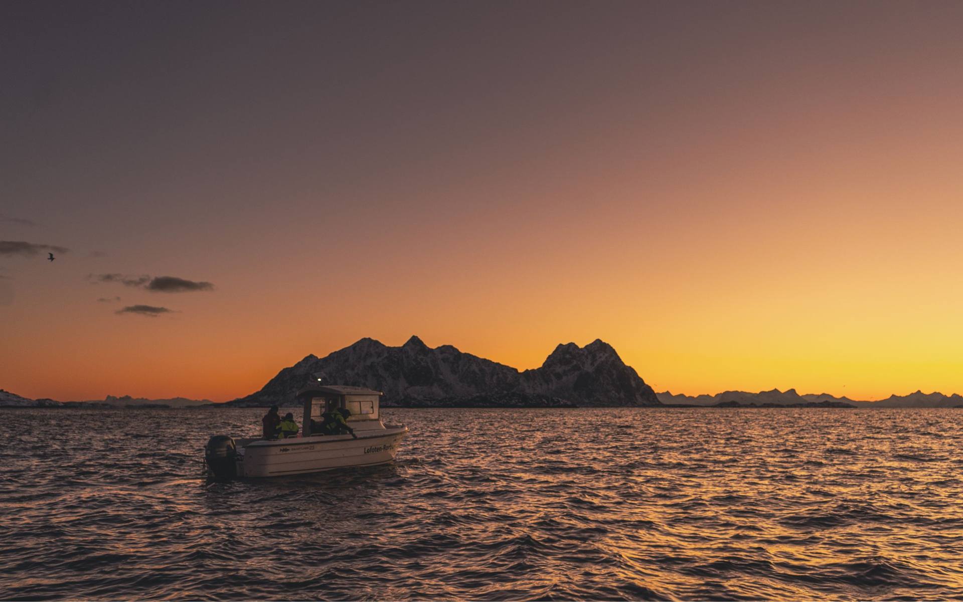 A small boat at sunset off the Lofoten coast