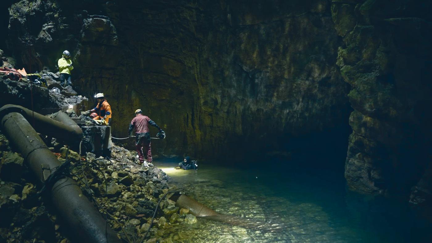 Team preparing a cave dive in an underground lake
