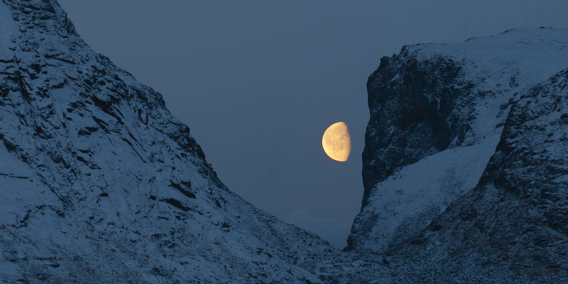 Moonrise between snowy peaks